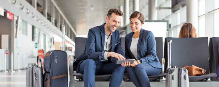 Allianz - business travelers looking at tablet