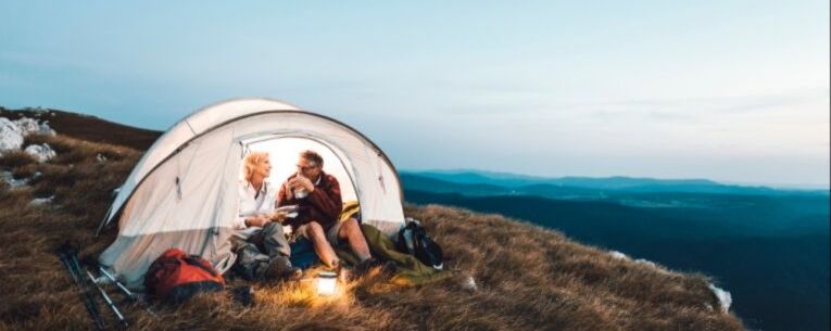 Allianz - senior couple camping on mountainside