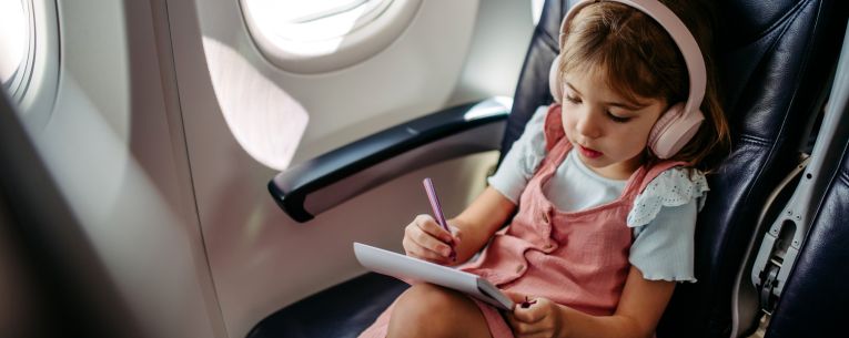 Allianz - girl on airplane wearing headphones