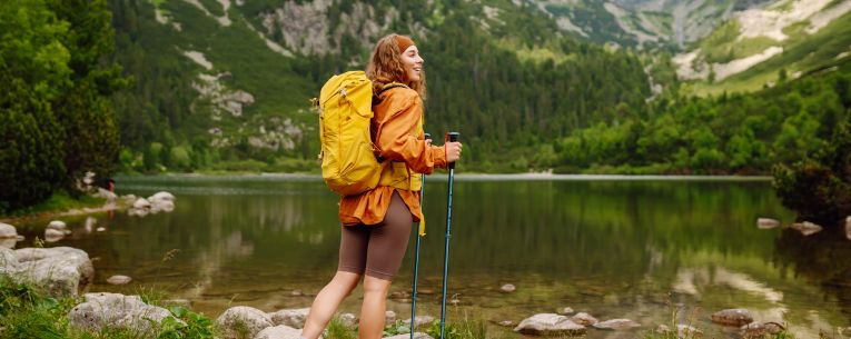 Allianz - traveler hiking by a lake