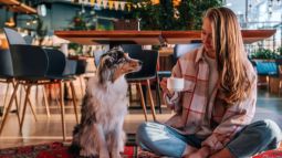 woman with her dog in a coffee shop